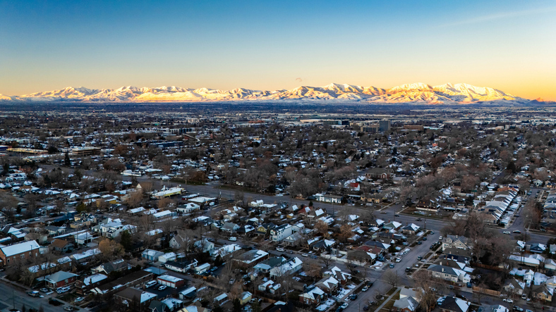 Aerial view of Salt Lake City against mountain range.